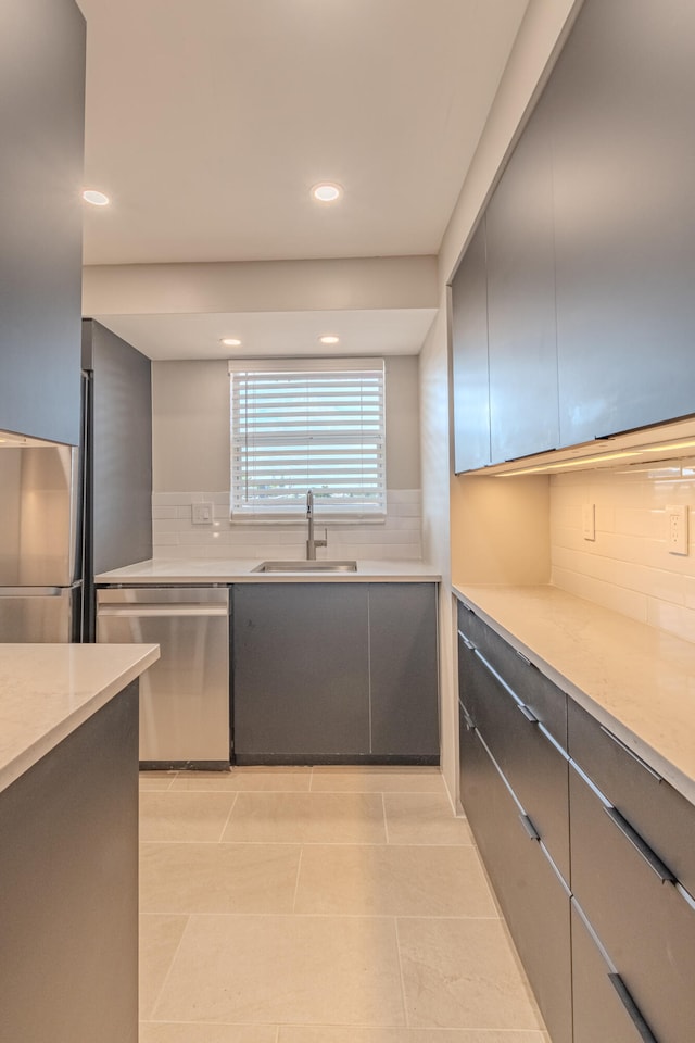 kitchen with decorative backsplash, sink, light tile patterned floors, and appliances with stainless steel finishes