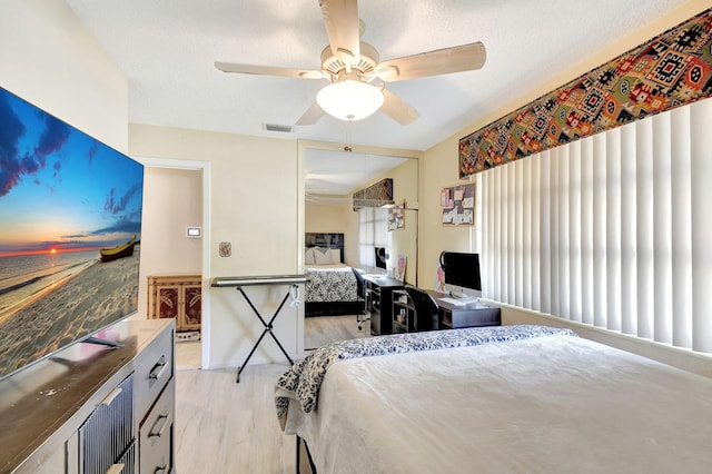 bedroom featuring ceiling fan and light hardwood / wood-style flooring