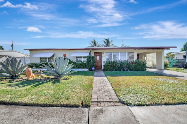 ranch-style home with a carport and a front yard