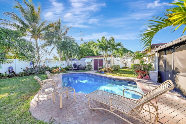 view of swimming pool with a yard and a patio area