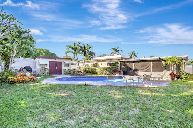 view of pool featuring a patio area and a lawn