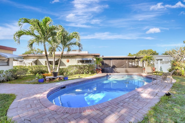 view of pool with a patio area and a sunroom