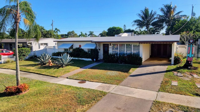 single story home with a front yard and a carport