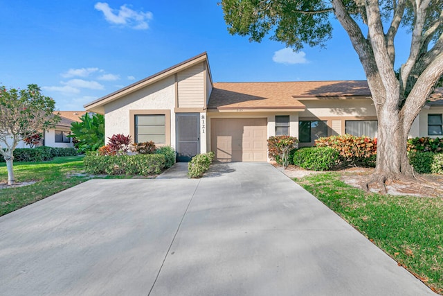 view of front of property with a garage and a front lawn