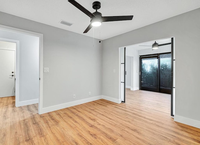 spare room with ceiling fan and light hardwood / wood-style floors