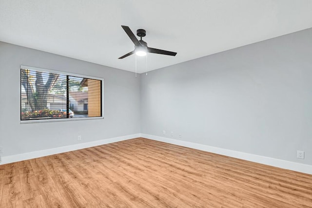 spare room with light wood-type flooring and ceiling fan