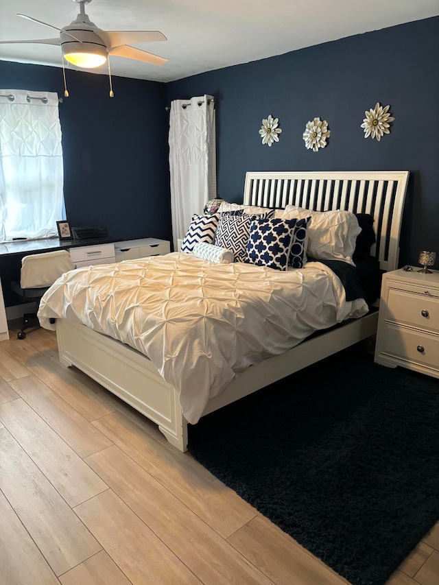 bedroom featuring light hardwood / wood-style flooring and ceiling fan