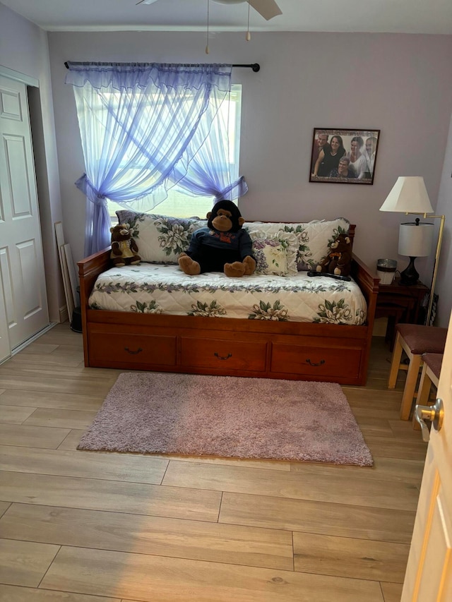 bedroom with multiple windows, ceiling fan, and light wood-type flooring