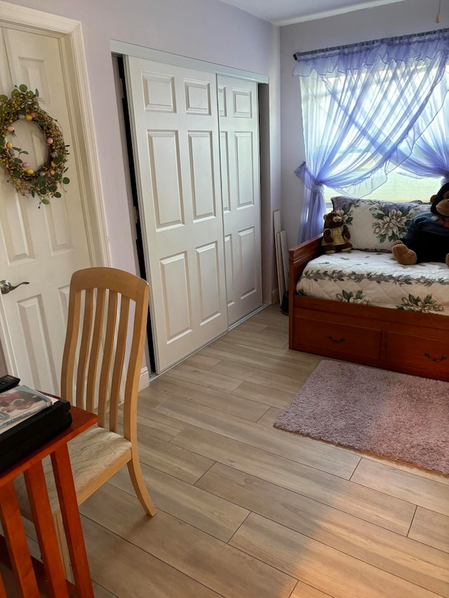 bedroom featuring light hardwood / wood-style floors and a closet