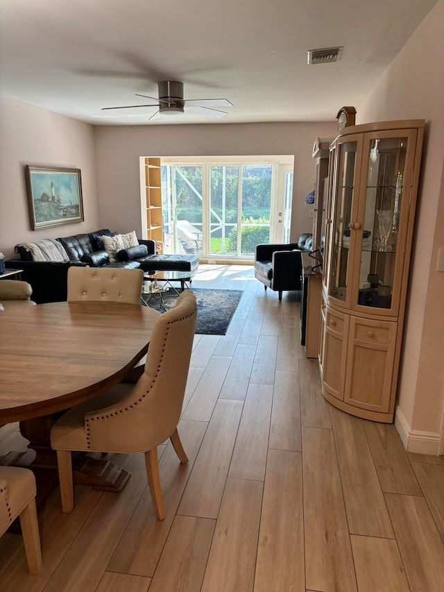 dining area with ceiling fan and light hardwood / wood-style floors