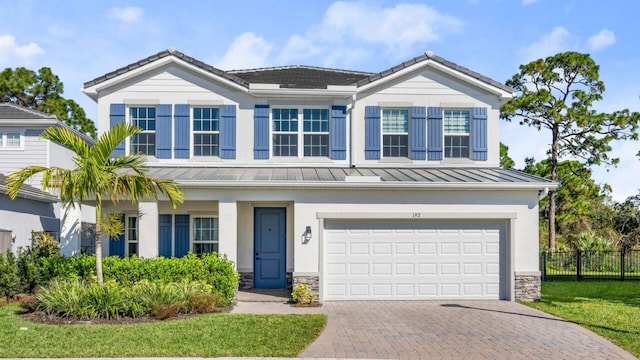 view of front of property with a garage and a front lawn