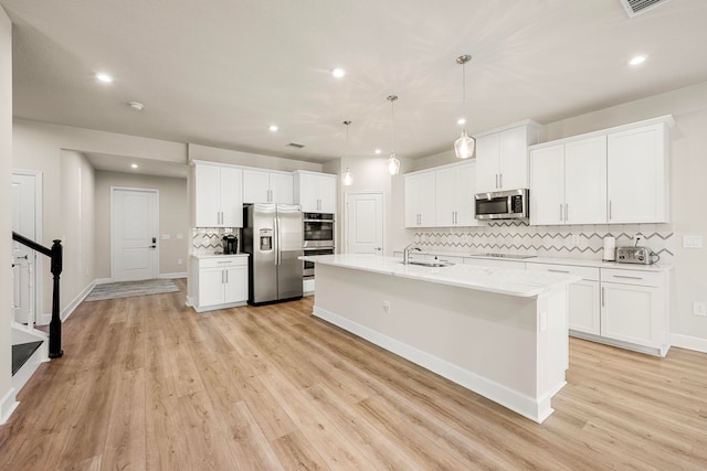 kitchen with sink, white cabinetry, and stainless steel appliances