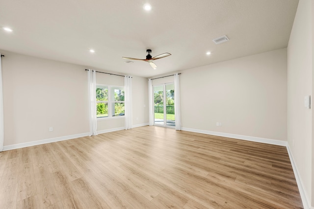 unfurnished room with ceiling fan and light hardwood / wood-style floors