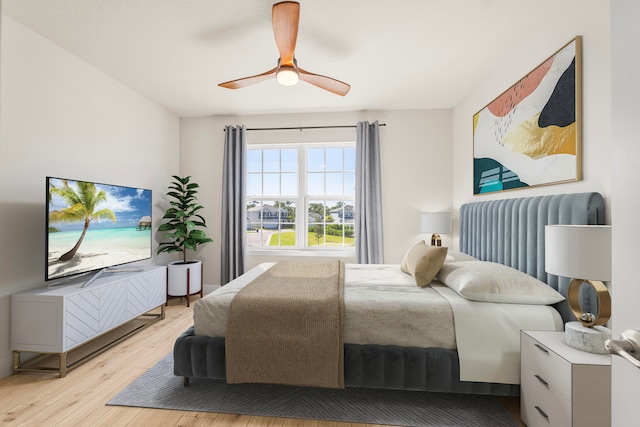 bedroom featuring radiator heating unit, light wood-type flooring, and ceiling fan