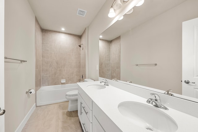 full bathroom featuring vanity, tile patterned flooring, tiled shower / bath, and toilet