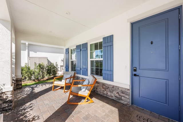 view of exterior entry featuring a porch