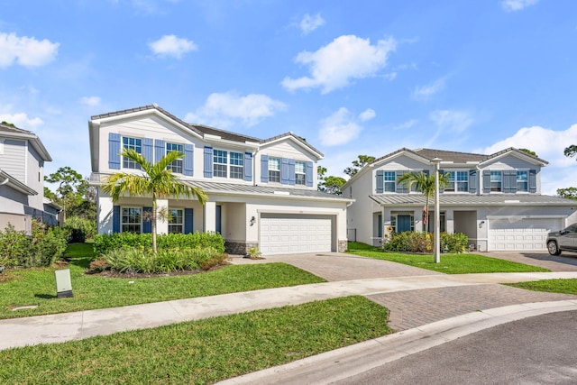 view of front of house featuring a front lawn and a garage