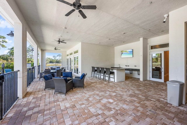 view of patio / terrace with ceiling fan, exterior bar, and an outdoor hangout area