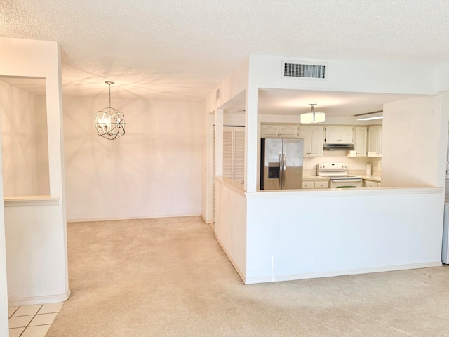 kitchen with white electric range oven, stainless steel fridge, pendant lighting, and light carpet