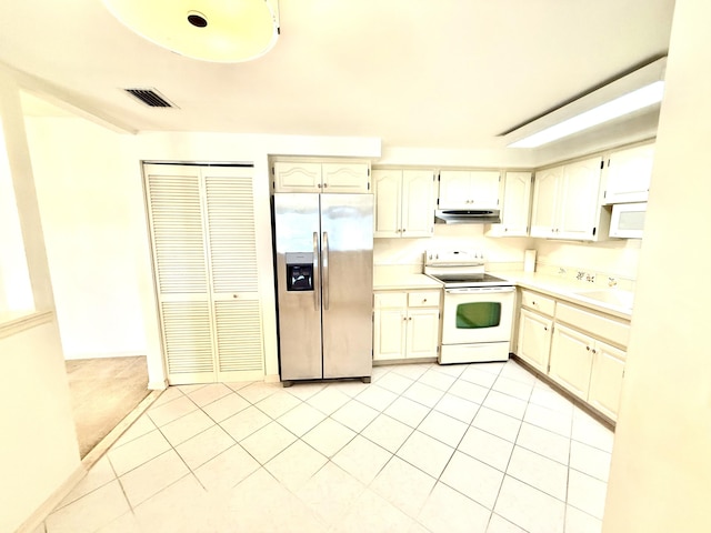 200 SE Four Winds Dr Unit 213, Stuart, FL 34996 - kitchen featuring white appliances, light countertops, under cabinet range hood, and light tile patterned flooring