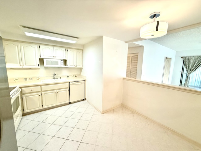 200 SE Four Winds Dr Unit 213, Stuart, FL 34996 - kitchen with white appliances, light countertops, hanging light fixtures, and light tile patterned flooring