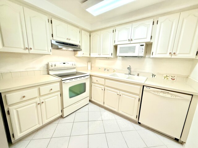 200 SE Four Winds Dr Unit 213, Stuart, FL 34996 - kitchen with white appliances, under cabinet range hood, light tile patterned floors, and light countertops