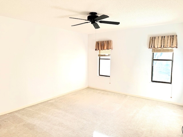 unfurnished room with carpet, a textured ceiling, plenty of natural light, and ceiling fan