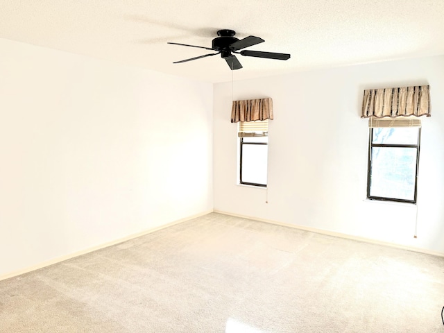 200 SE Four Winds Dr Unit 213, Stuart, FL 34996 - empty room featuring light colored carpet, a ceiling fan, and a textured ceiling