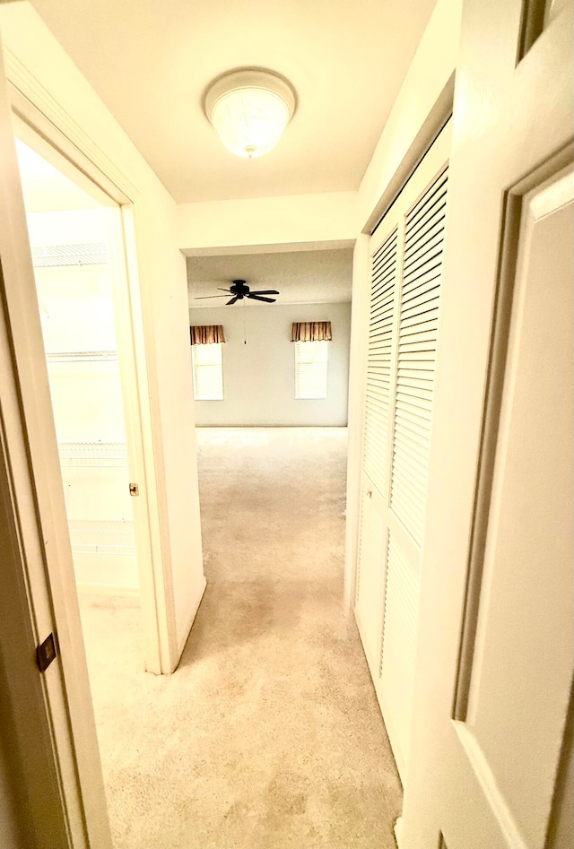 hallway with light colored carpet