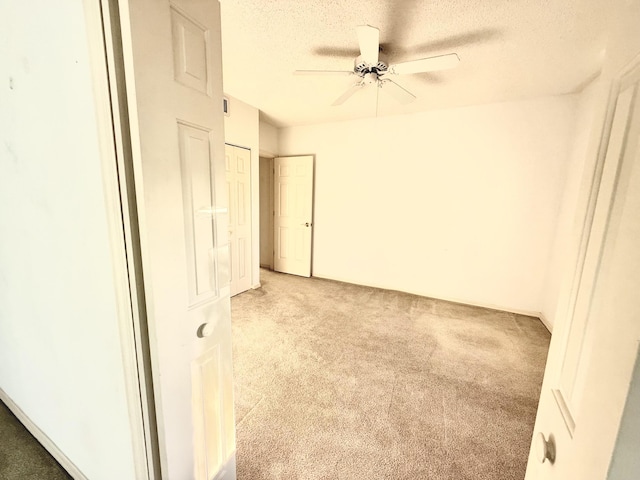 200 SE Four Winds Dr Unit 213, Stuart, FL 34996 - unfurnished room with light colored carpet, ceiling fan, and a textured ceiling