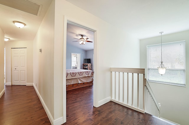 hallway with dark hardwood / wood-style floors