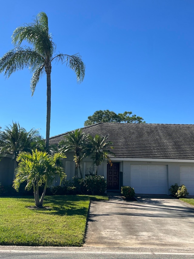 view of front of home featuring a front yard and a garage