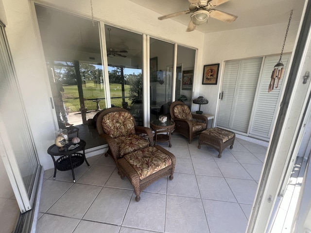 sunroom / solarium featuring a ceiling fan