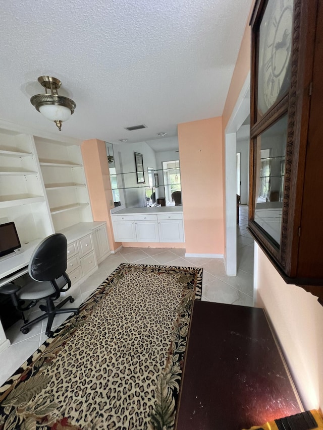 office with light tile patterned flooring and a textured ceiling