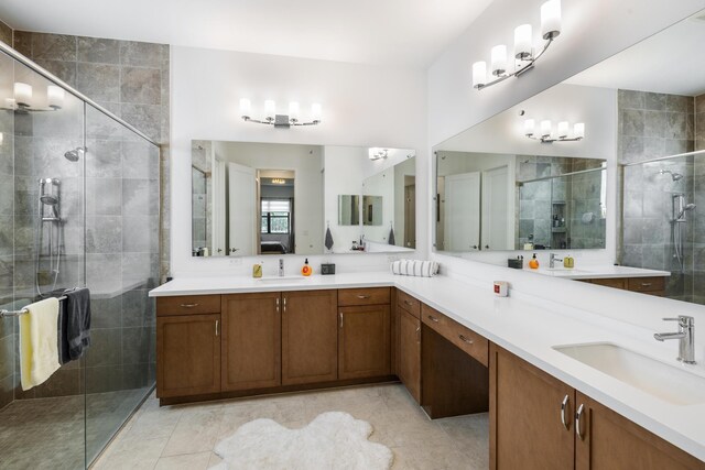 kitchen featuring a spacious island, wall chimney range hood, sink, light stone counters, and stainless steel appliances