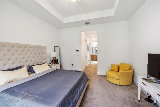 bedroom with carpet and a tray ceiling