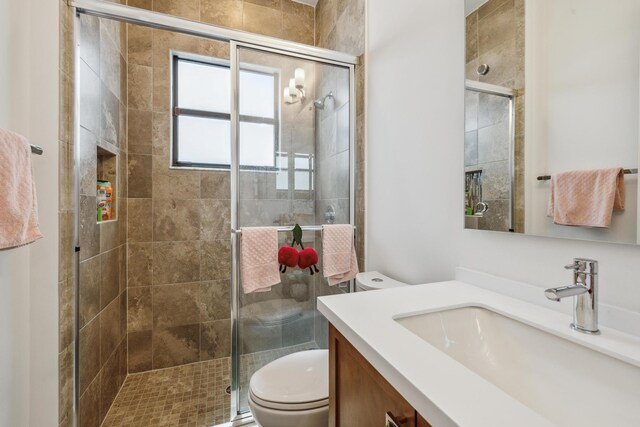 bathroom featuring tile patterned flooring, vanity, and an enclosed shower