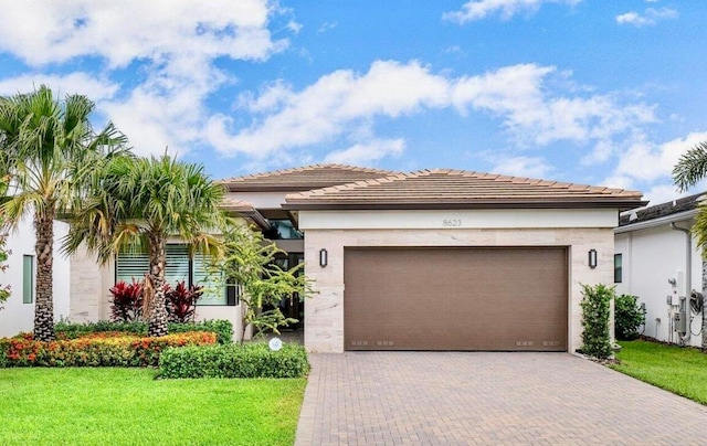 view of front of home with a garage and a front yard