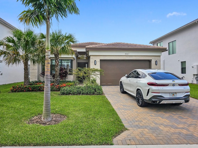 view of front of property featuring a garage and a front yard