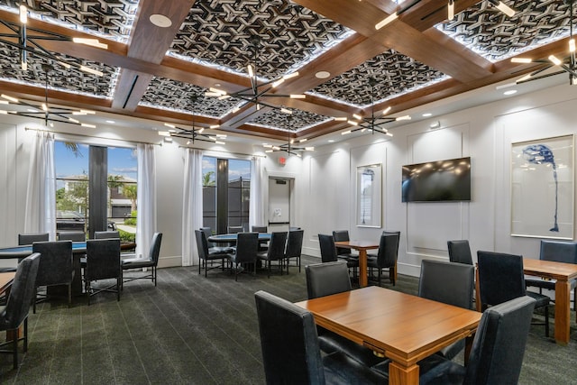 carpeted dining space with beam ceiling, coffered ceiling, and a notable chandelier