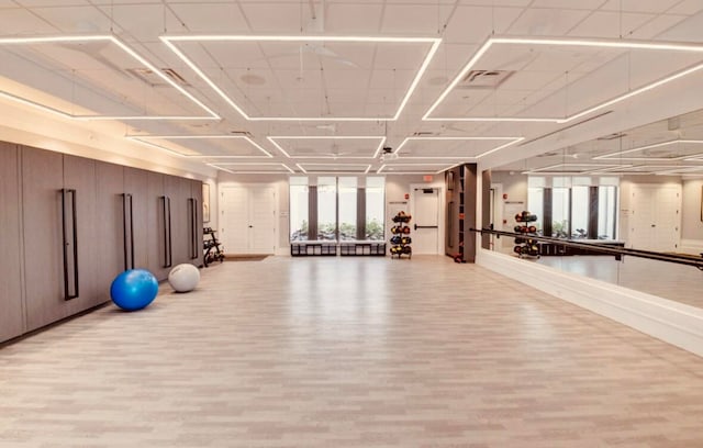 gym with light hardwood / wood-style floors