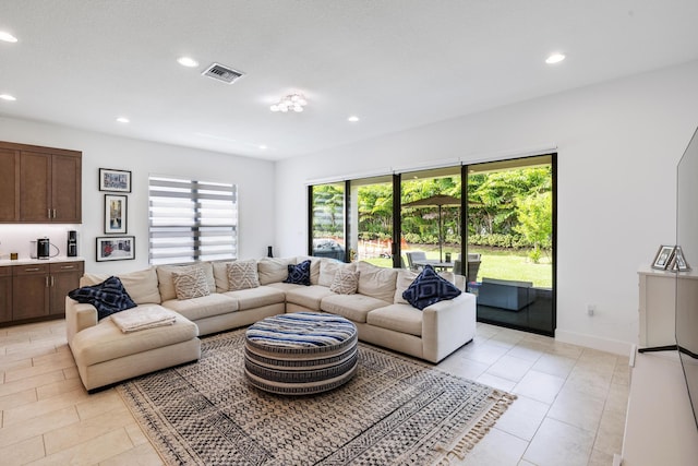 living room with light tile patterned floors and a healthy amount of sunlight