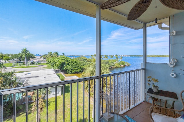 balcony with a water view and ceiling fan