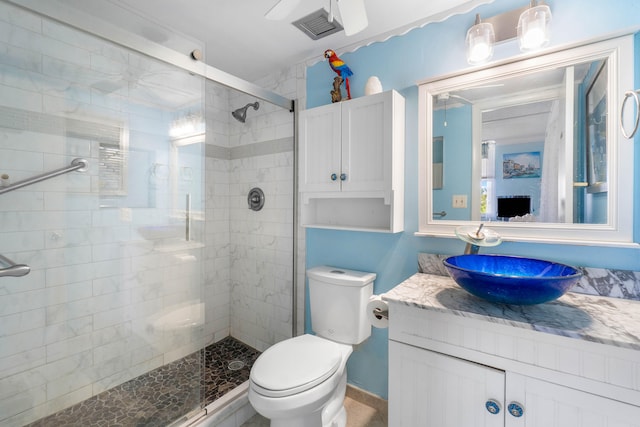 bathroom featuring vanity, toilet, and walk in shower