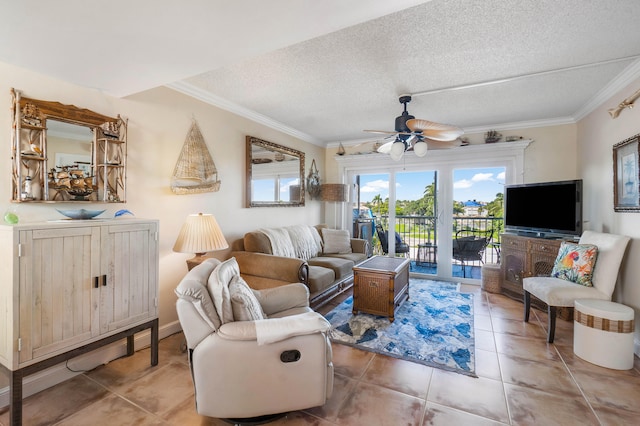 living room featuring tile patterned flooring, ceiling fan, ornamental molding, and a textured ceiling