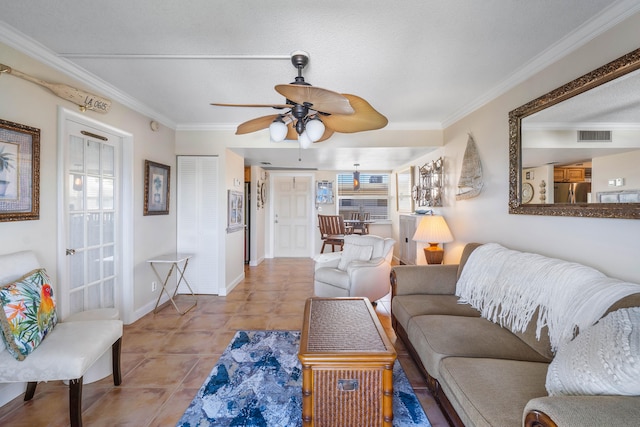 living room featuring ceiling fan, light tile patterned floors, and crown molding