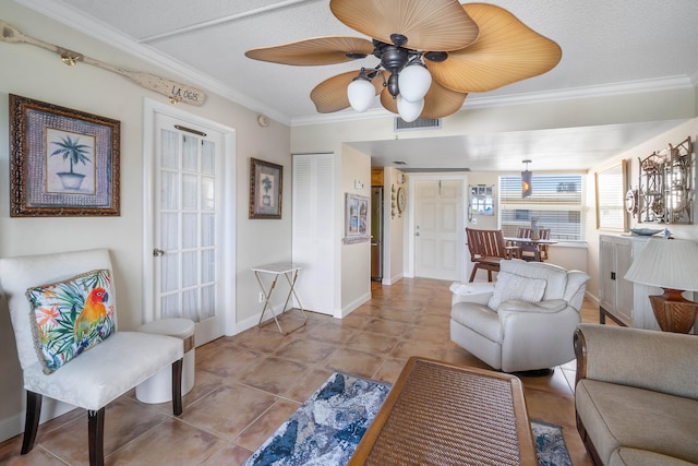 living room featuring a textured ceiling, ceiling fan, light tile patterned floors, and crown molding