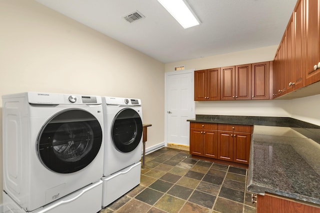 washroom featuring independent washer and dryer and cabinets