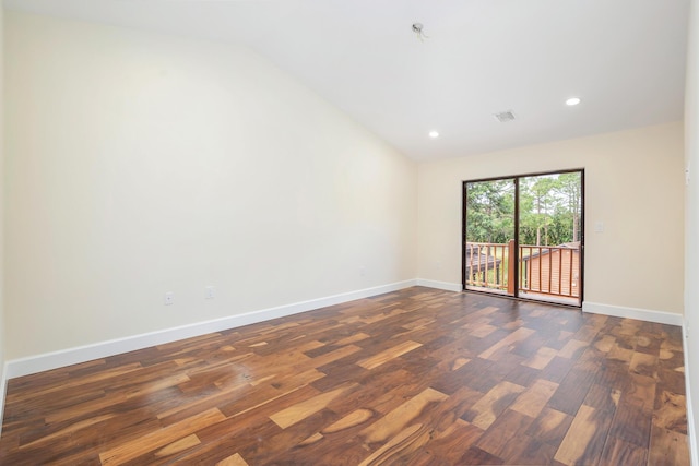 unfurnished room featuring lofted ceiling and dark wood-type flooring