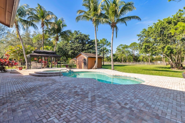 view of swimming pool with a gazebo, a storage unit, a patio, and an in ground hot tub